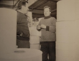 Geoffrey and Brian talking together in the factory