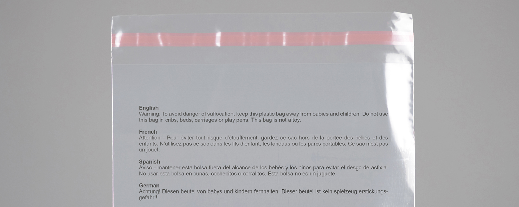 A printed warning notice on the exterior of a polythtne bag